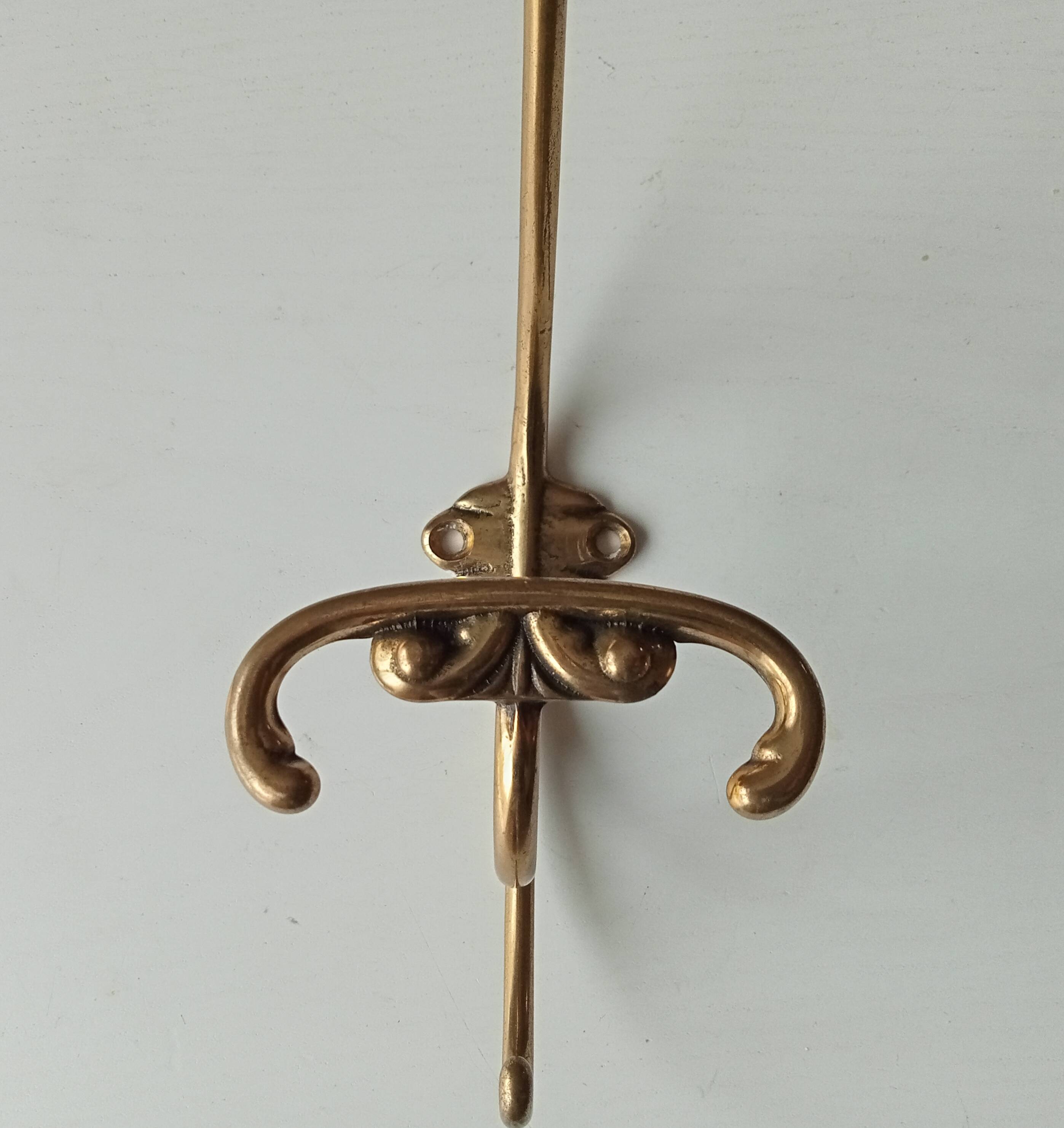 Old coat hook in solid golden brass