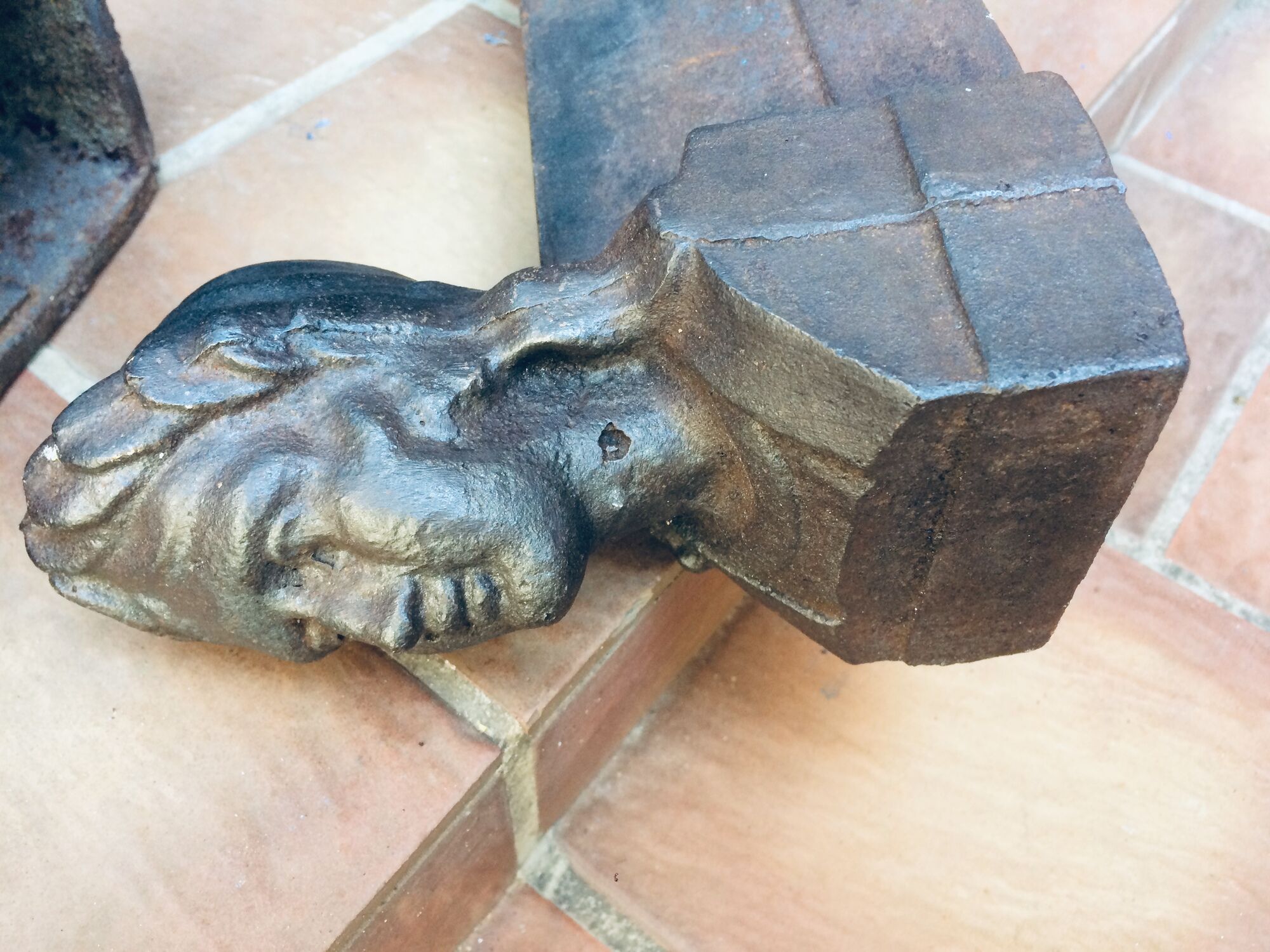 Pair of cast-iron chenet characters with laurels