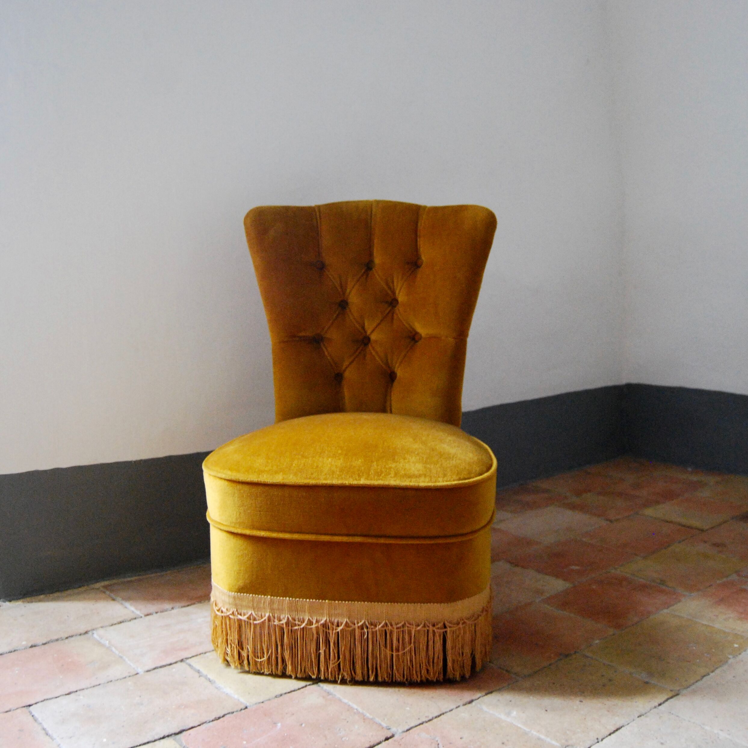Toad in yellow velvet armchair