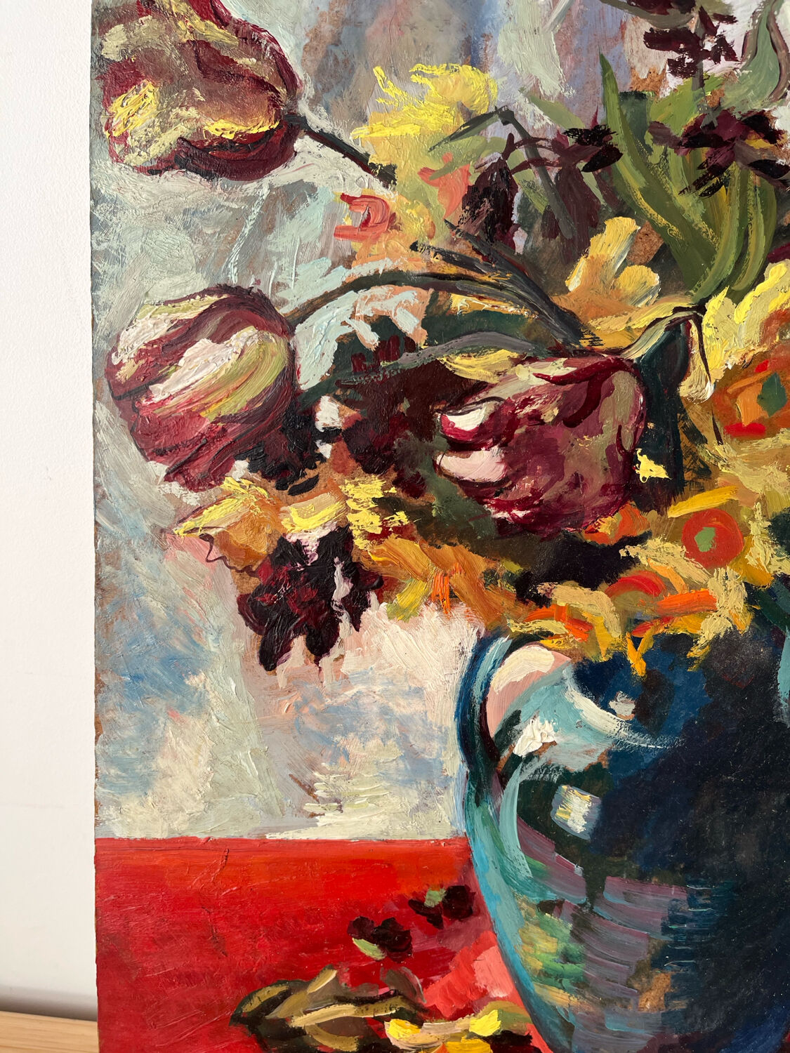 Bouquet of flowers on a red tablecloth, knife on a board, signed Renzo.