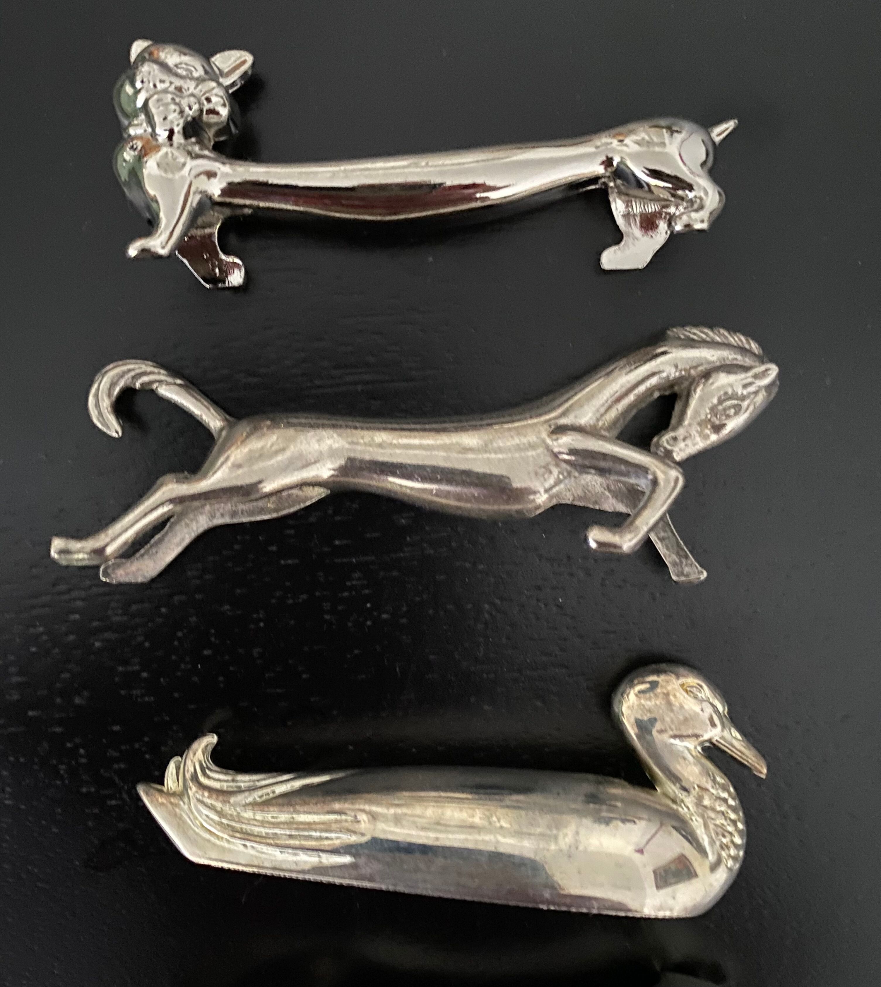 12 knife holders form various metal animals