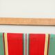 Vintage deck chair with striped green and red fabric, original patina.