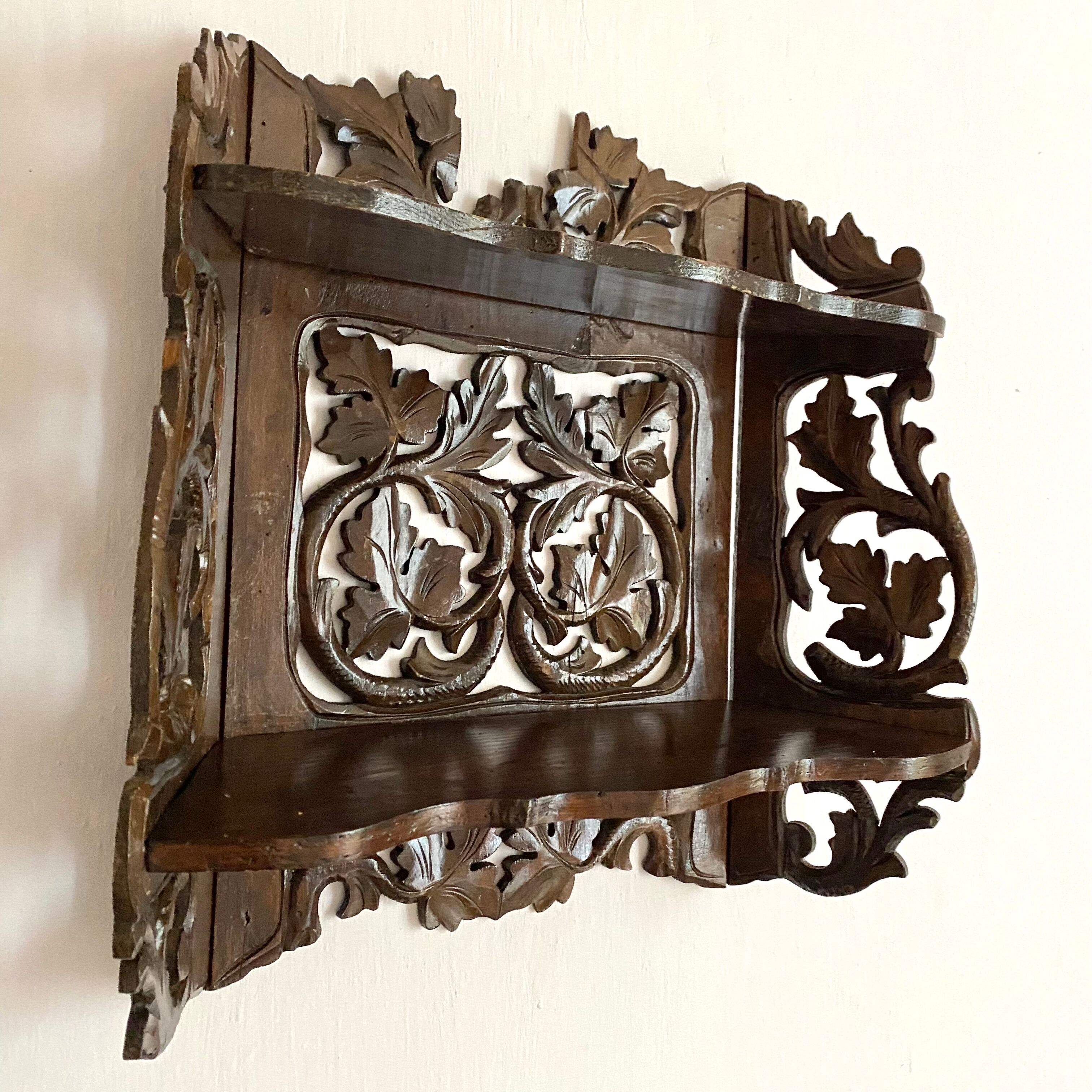Carved wooden wall shelf