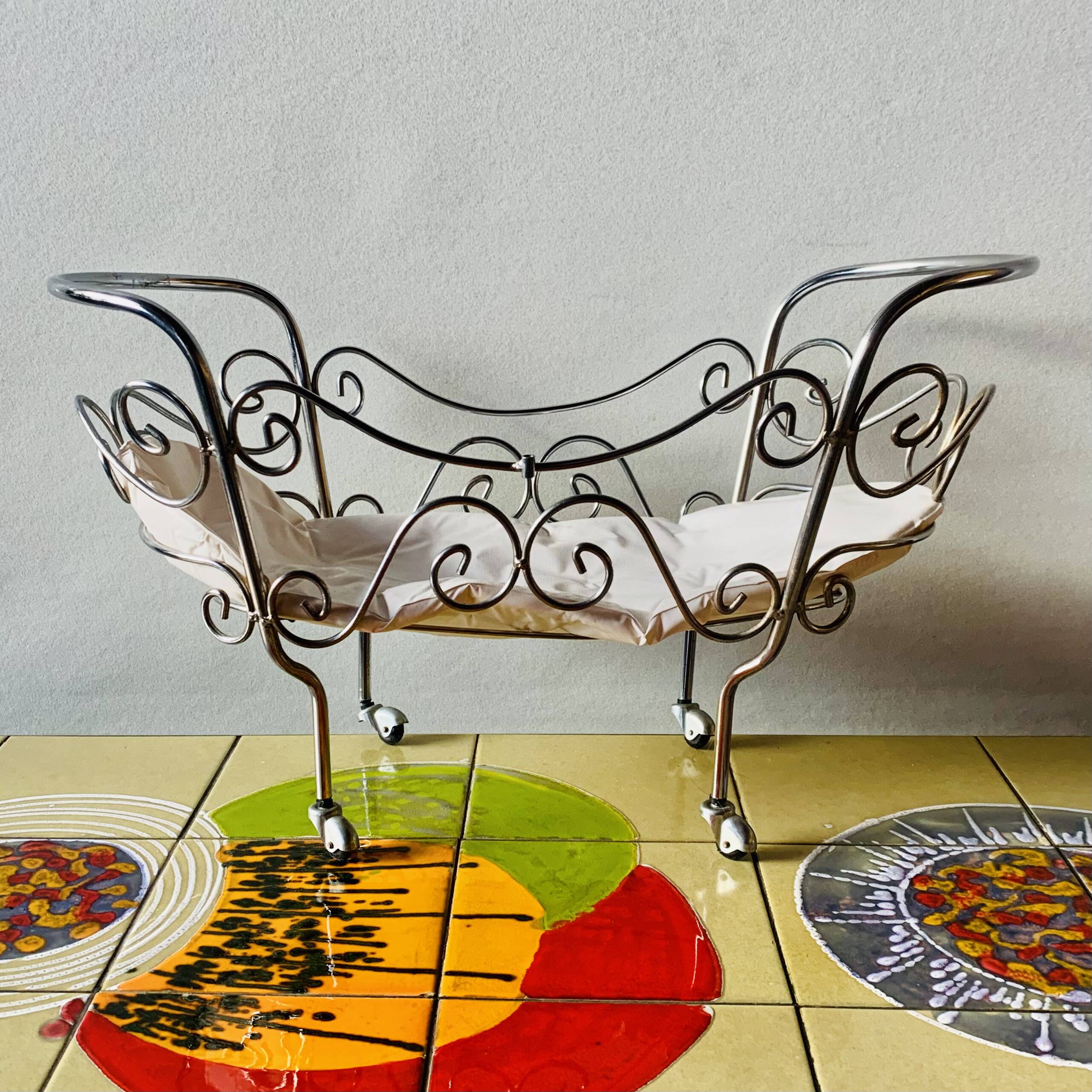 Metal doll's bed on vintage casters