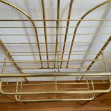 Gilded metal grid shelf in the shape of a vaulted arch