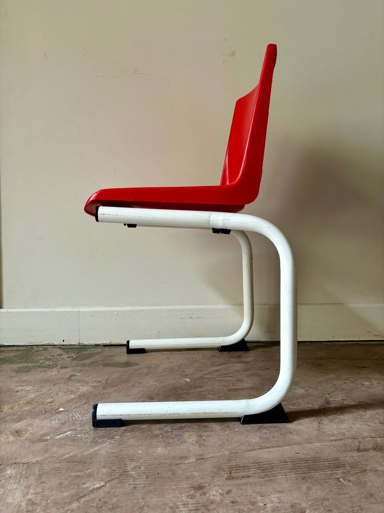 Children's chair in white metal and red plastic