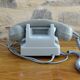 Grey vintage rotary dial phone with earpiece