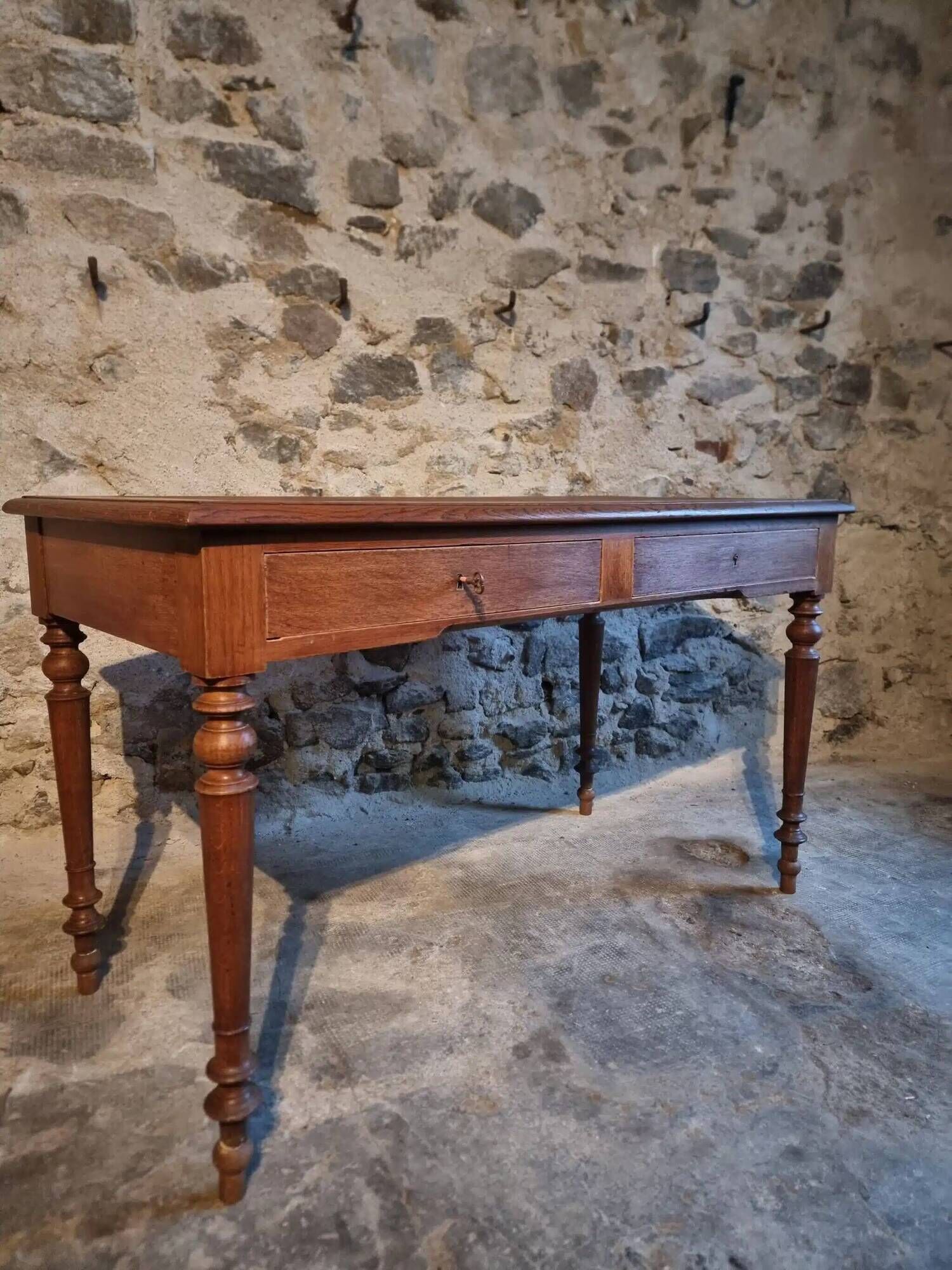 Antique French writing desk in oak with two drawers, 1920s.