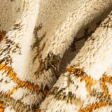 XXL Berber rug with long fringes from the 1960s. Cream-coloured pile with patterns in orange and green tones.