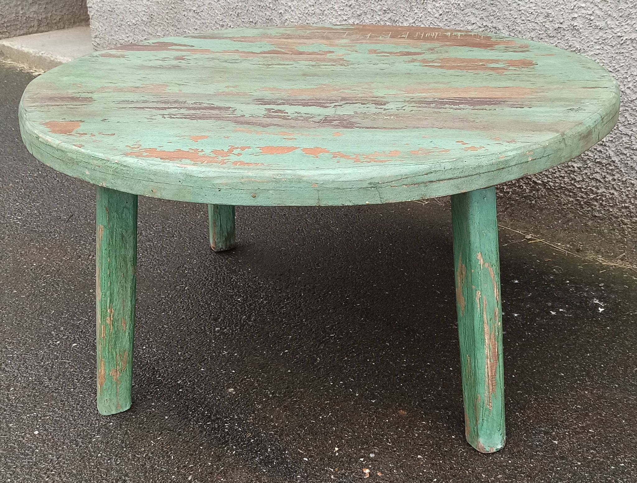 Round coffee table in old green wood