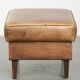 Cowhide ottoman with a beautiful patina finished with decorative nails