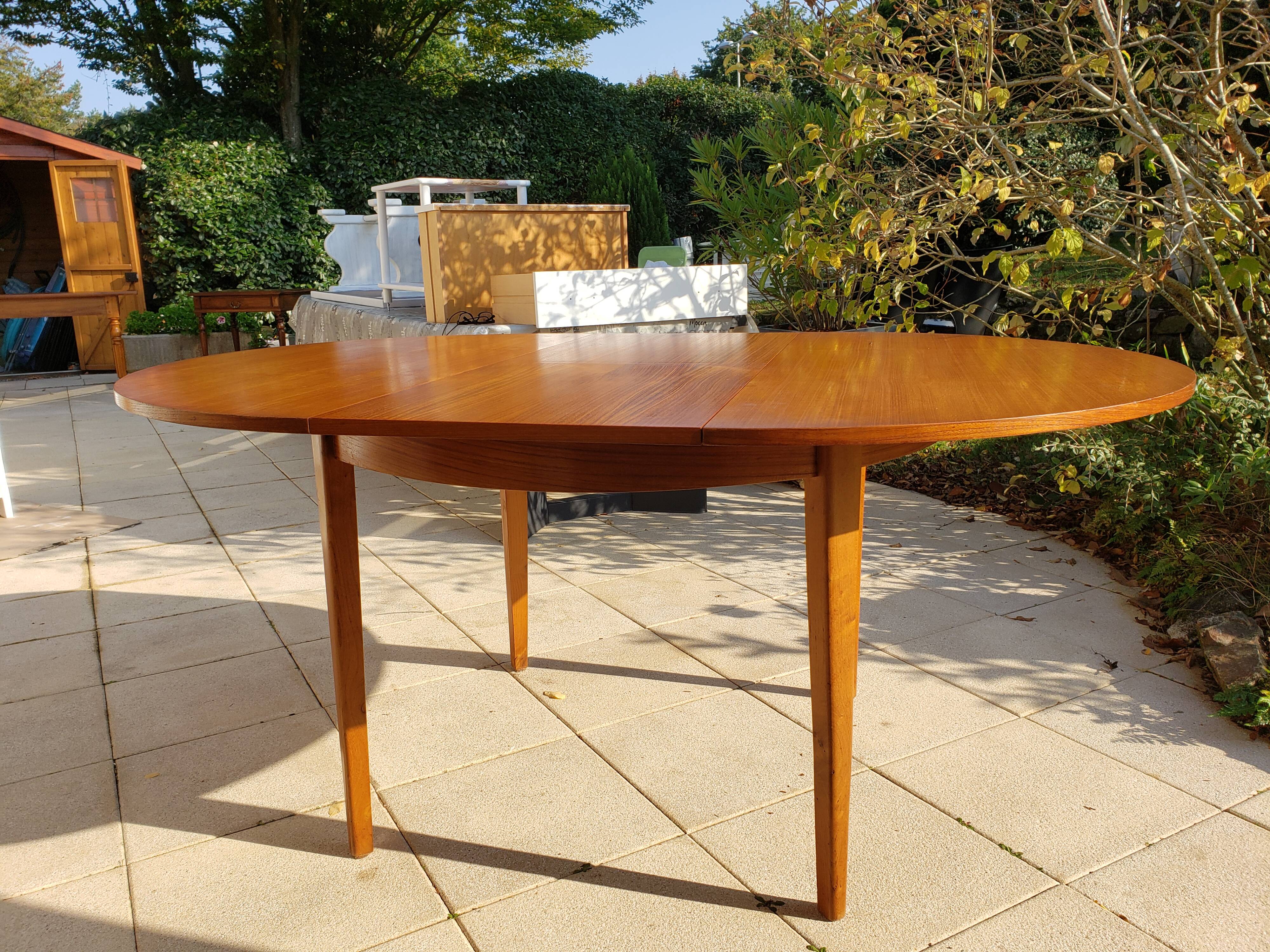Round extendable teak dining table from the 60s