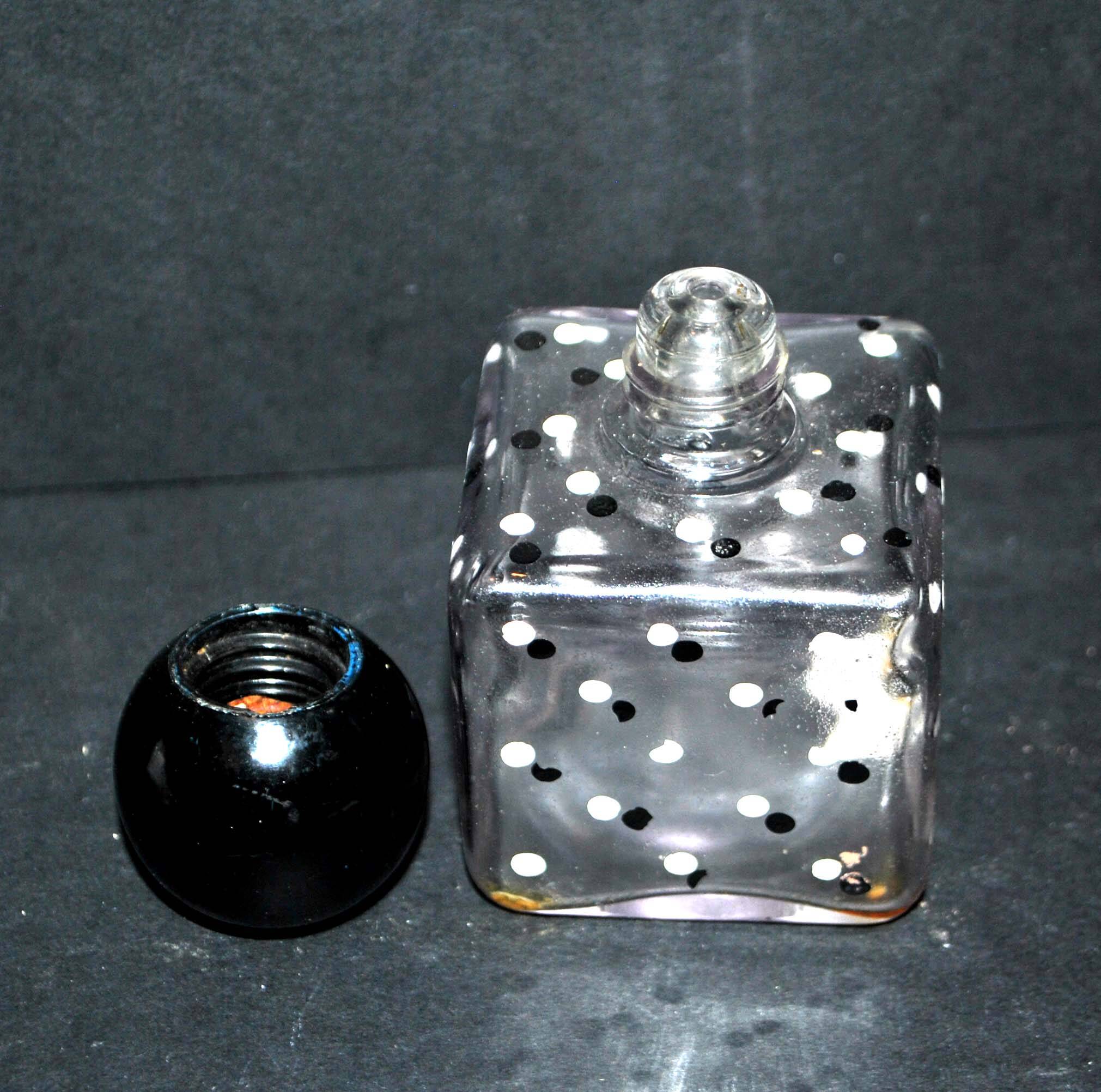 Vintage white and black polka dot glass perfume bottle and round bakelite cap