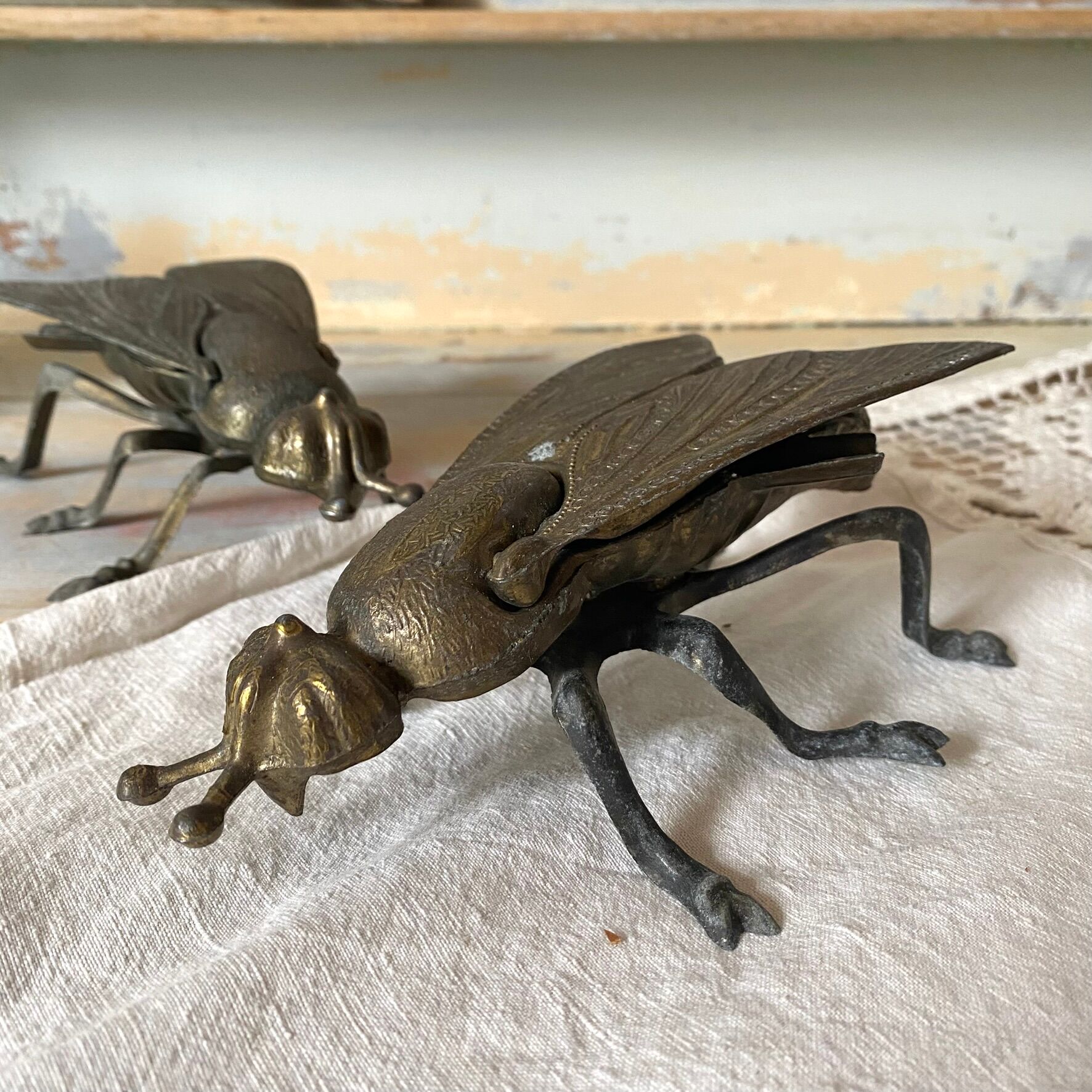 2 metal ashtrays with insect fly designs from the 1950s-60s.