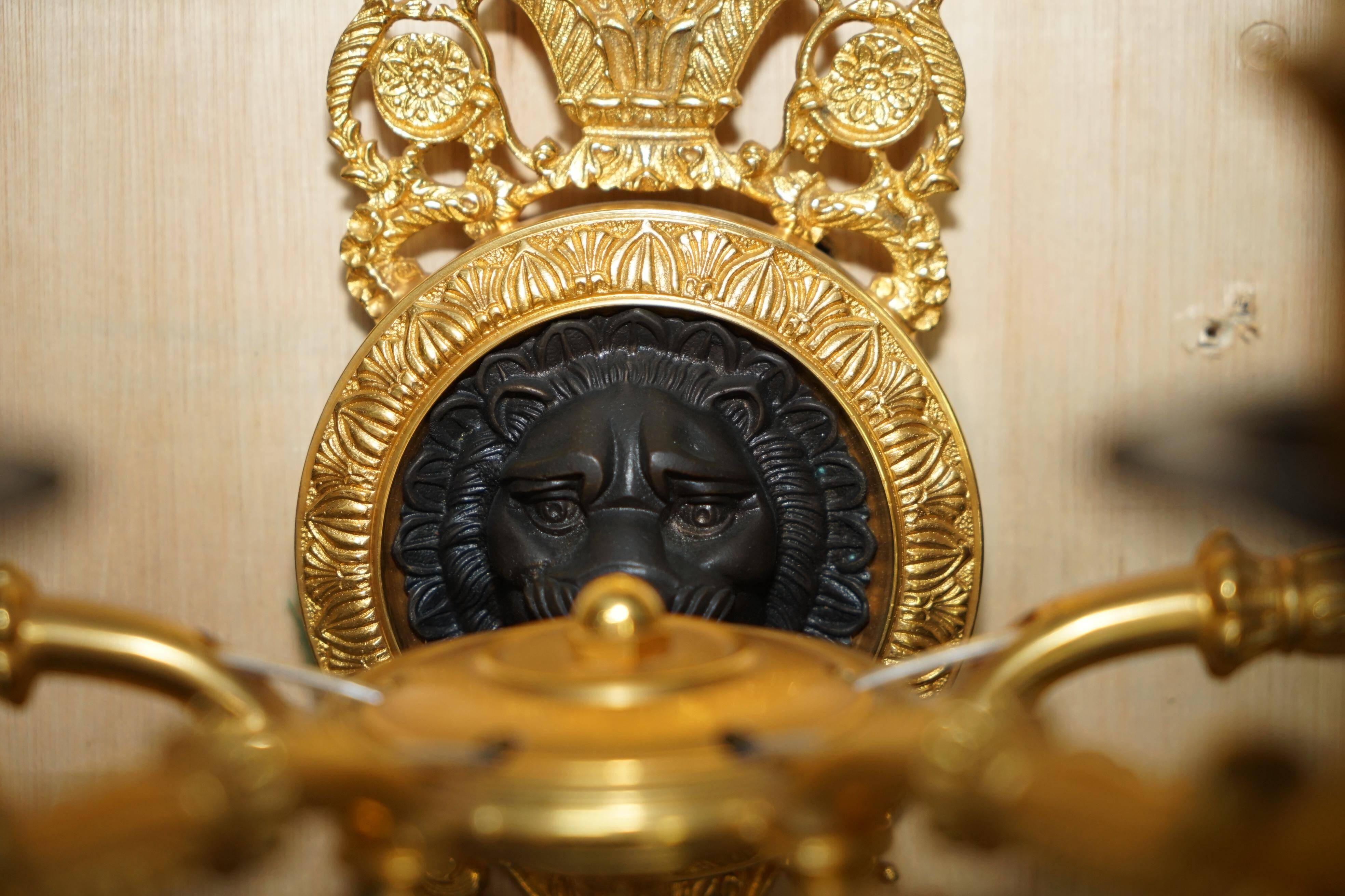 Pair of L'Originale wall sconces plated with 24-carat gold featuring four bronze candles.