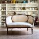 Two-seater basket bench in carved wood and beige mixed fabric, 18th century.