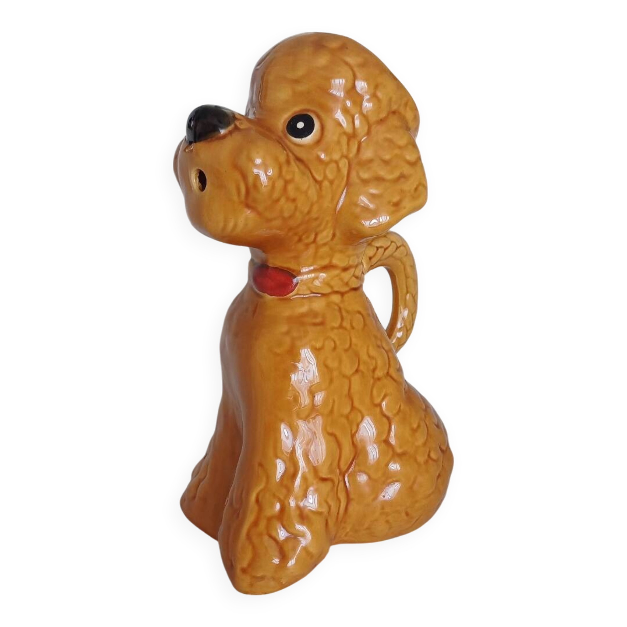 Ancient ceramic pitcher in the shape of a poodle.