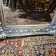 Beige patinated mirror with women's heads