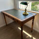 English-style wooden desk with a green leather writing pad.