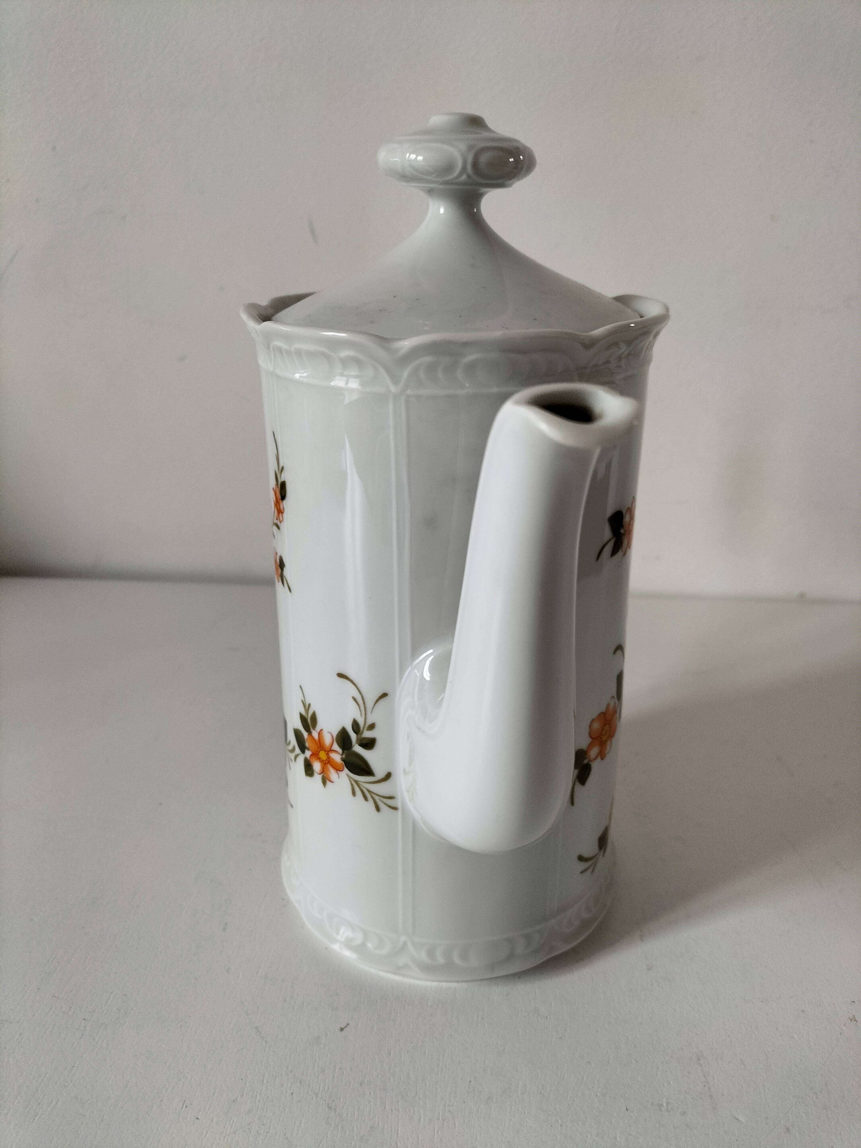 Vintage coffee pot Winterling Bavaria with orange floral decoration.