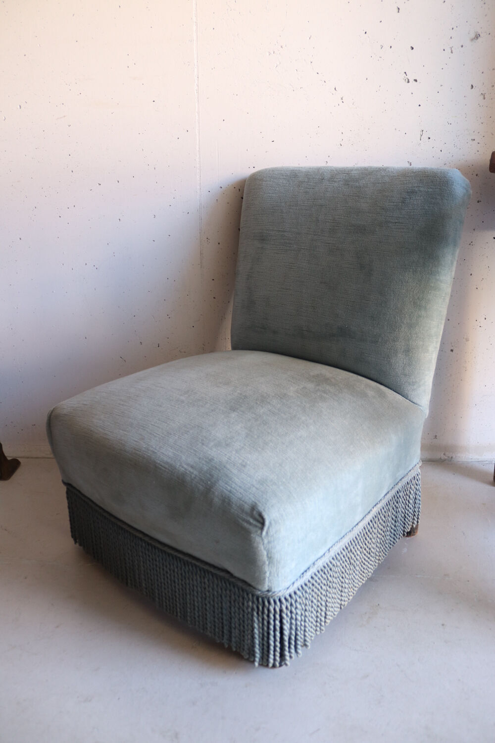 Vintage blue velvet fringed armchair.