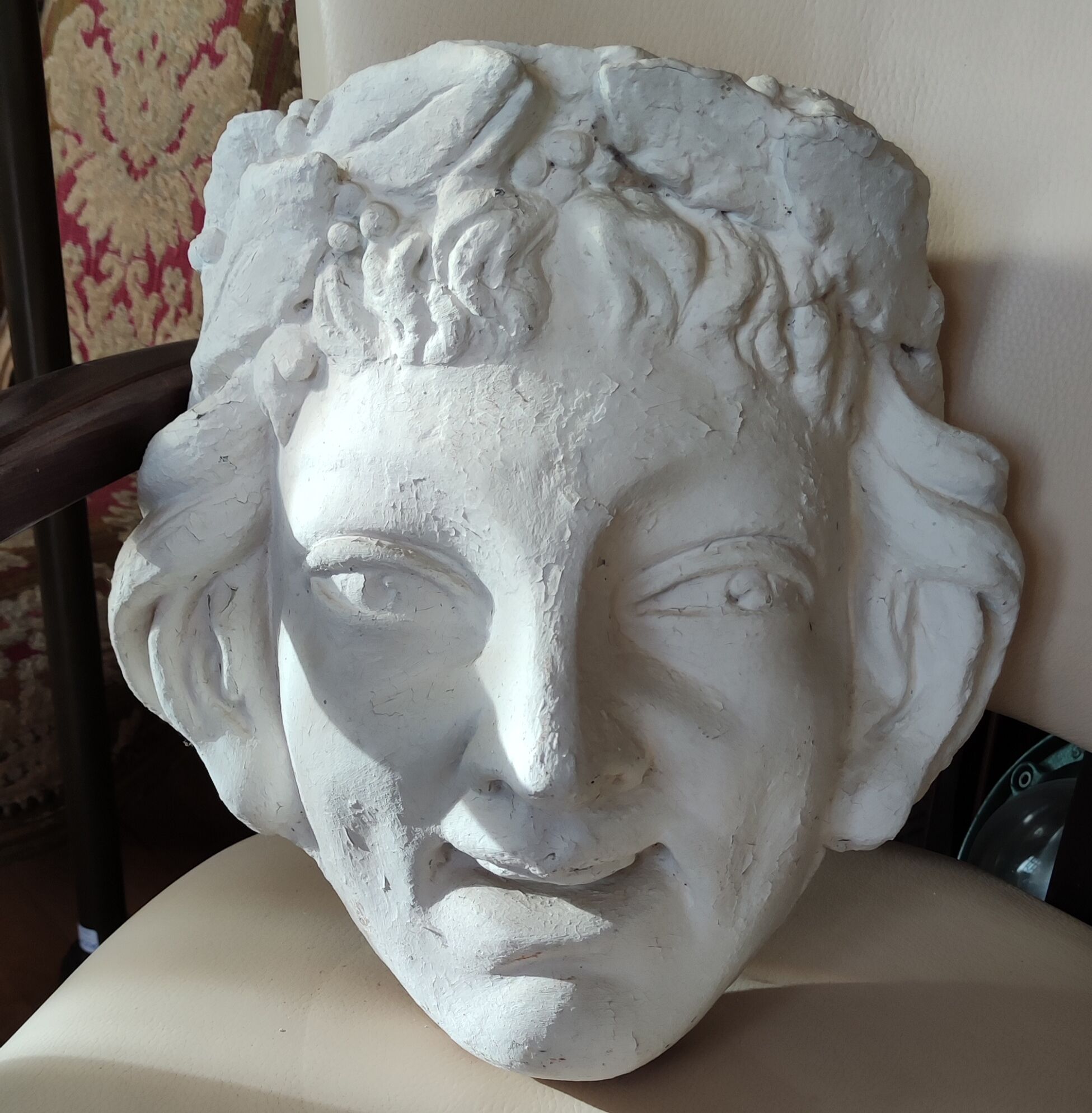 Old face in plaster antique decoration