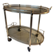 Neoclassical bar cart in gilded brass and smoked glass