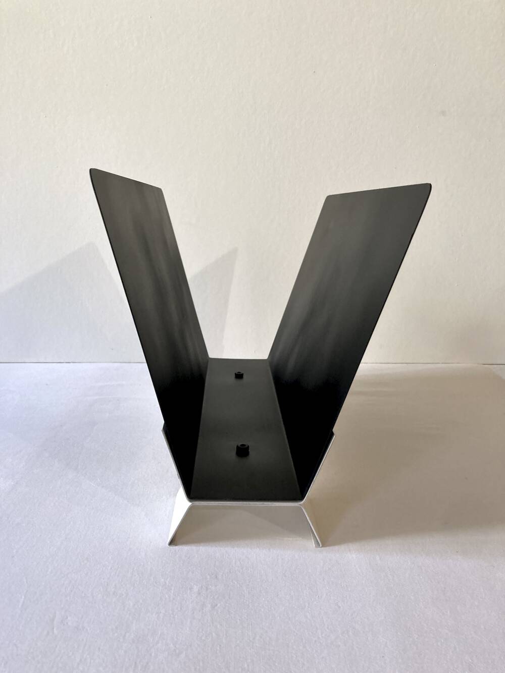 Black and cream metal magazine rack, 1950s.