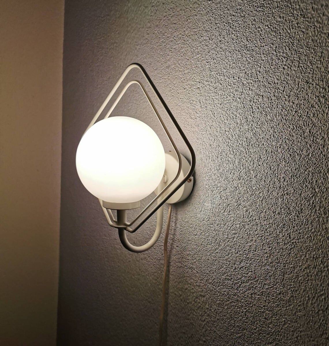 Metal applique with 80s glass sphere