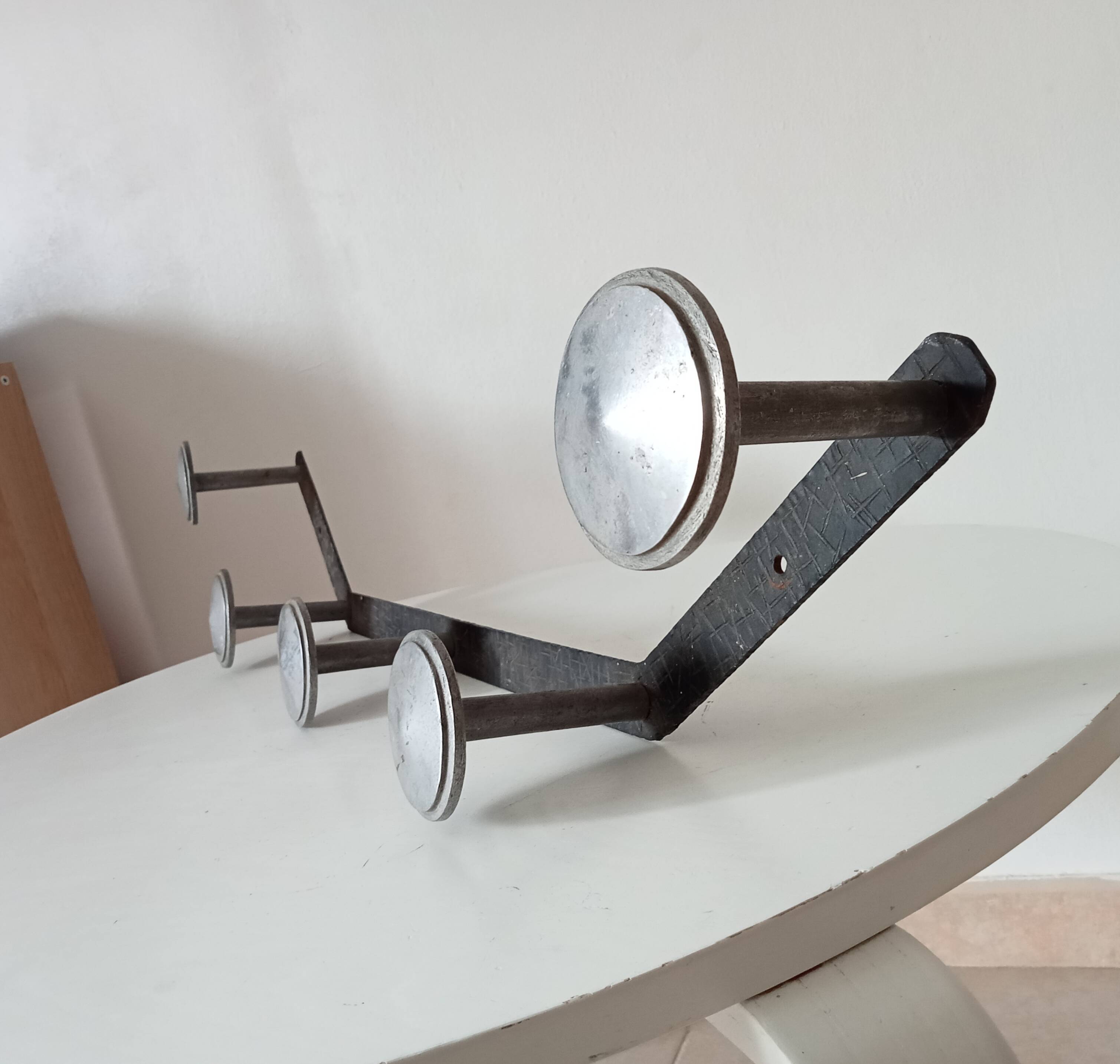 Vintage 1950s wall coat rack, wrought iron with chiselled details and solid aluminium.