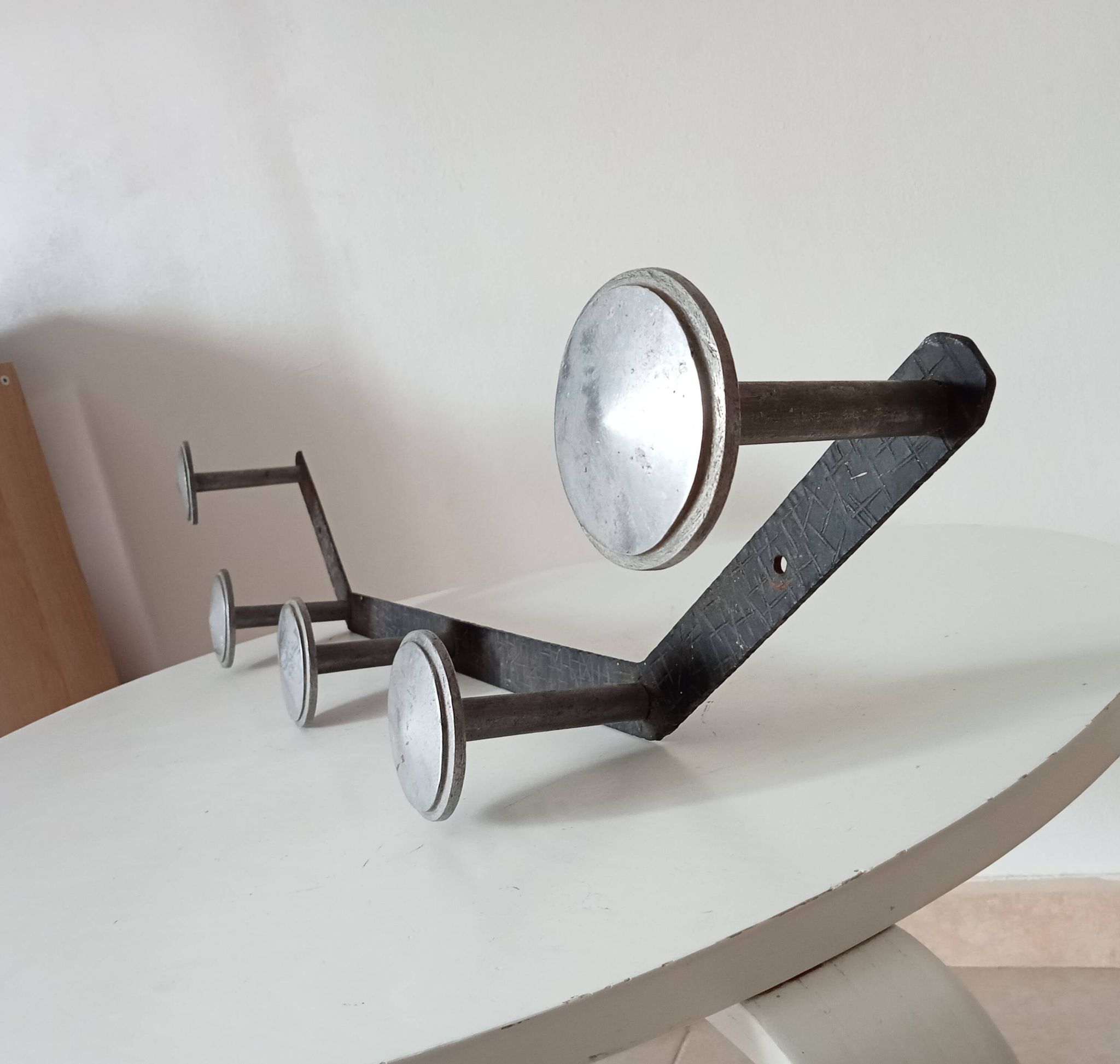 Vintage 1950s wall coat rack, wrought iron with chiselled details and solid aluminium.