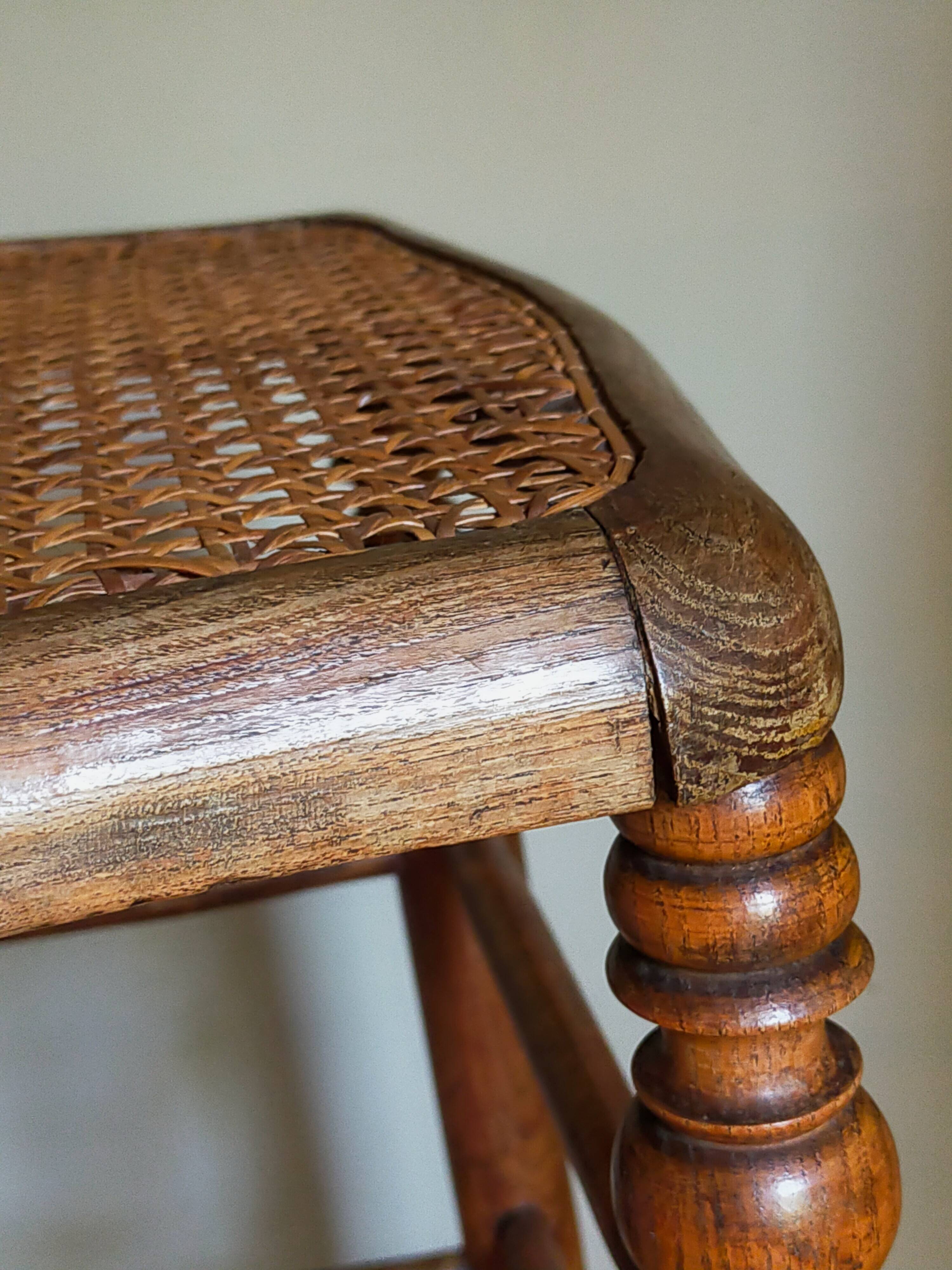 Antique stool with cane and turned wood