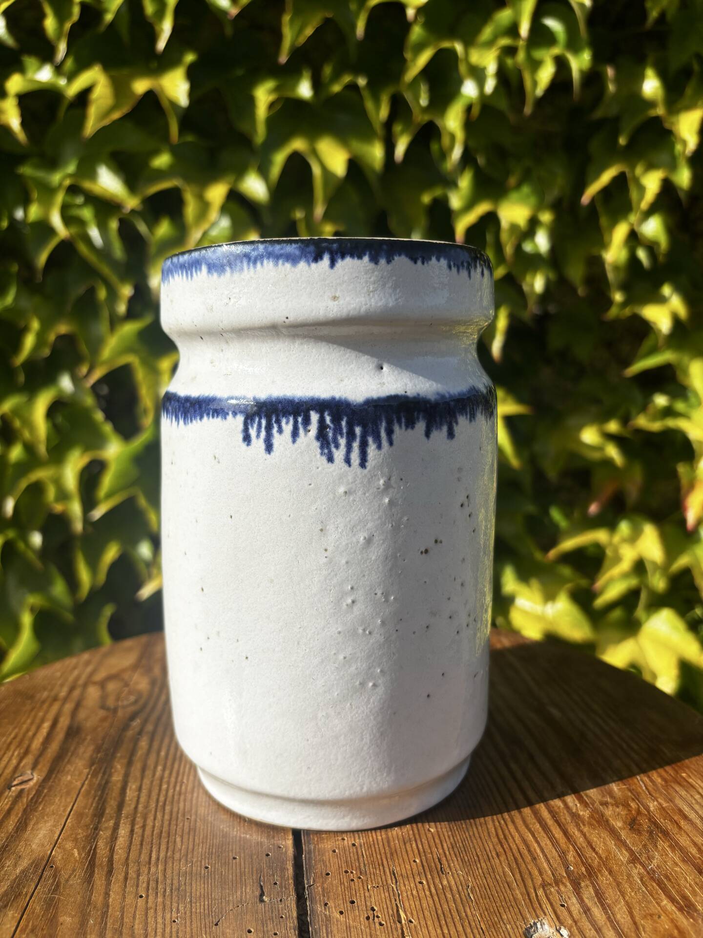 Pretty pot or vase in glazed stoneware with blue drip effect.