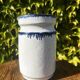 Pretty pot or vase in glazed stoneware with blue drip effect.