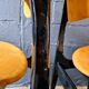 2 vintage chairs in black lacquered wood and yellow/mustard fabric, 1960