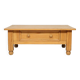 Rustic vintage style coffee table in light wood, mid-century modern design.