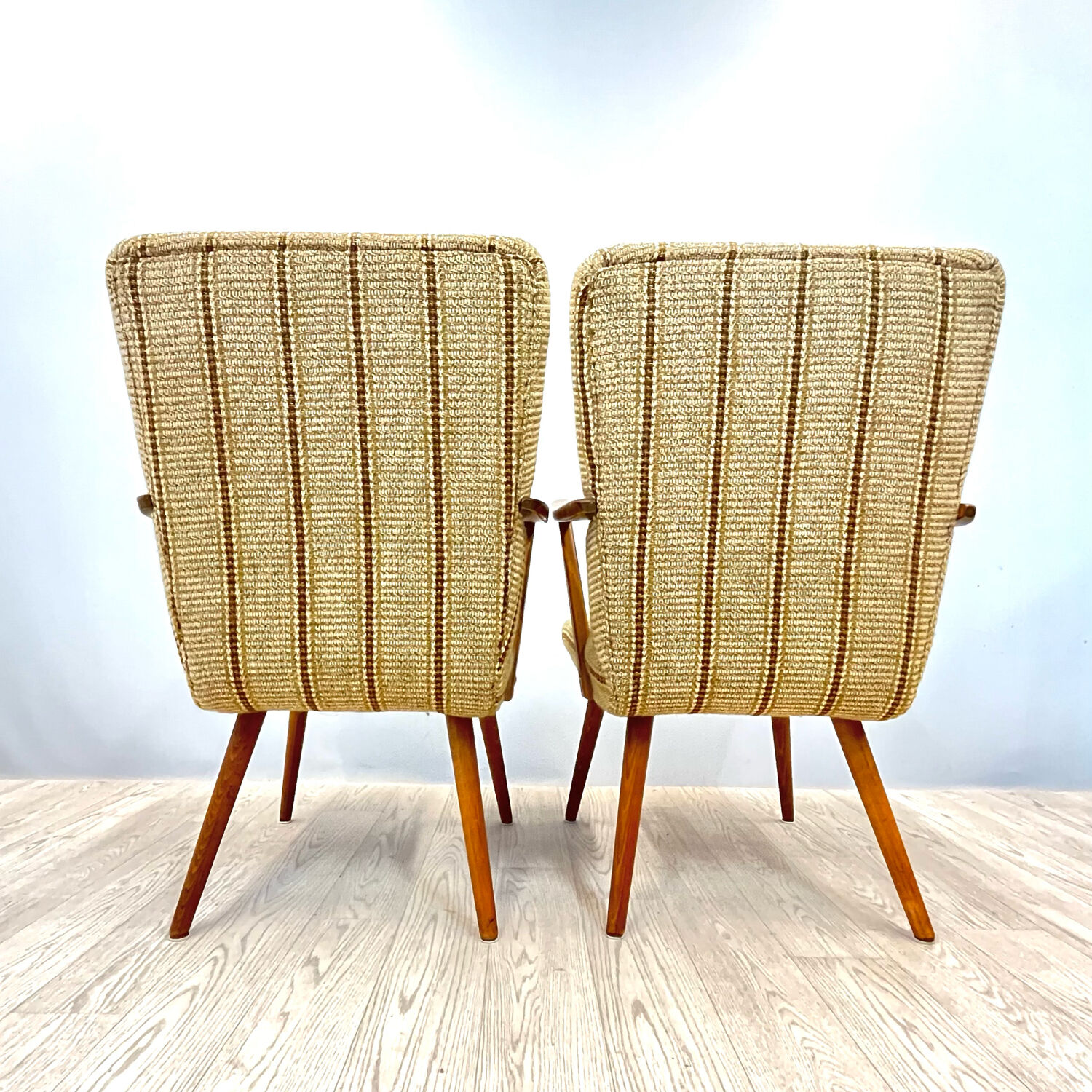 A pair vintage cocktail chairs with stripes and metal screws