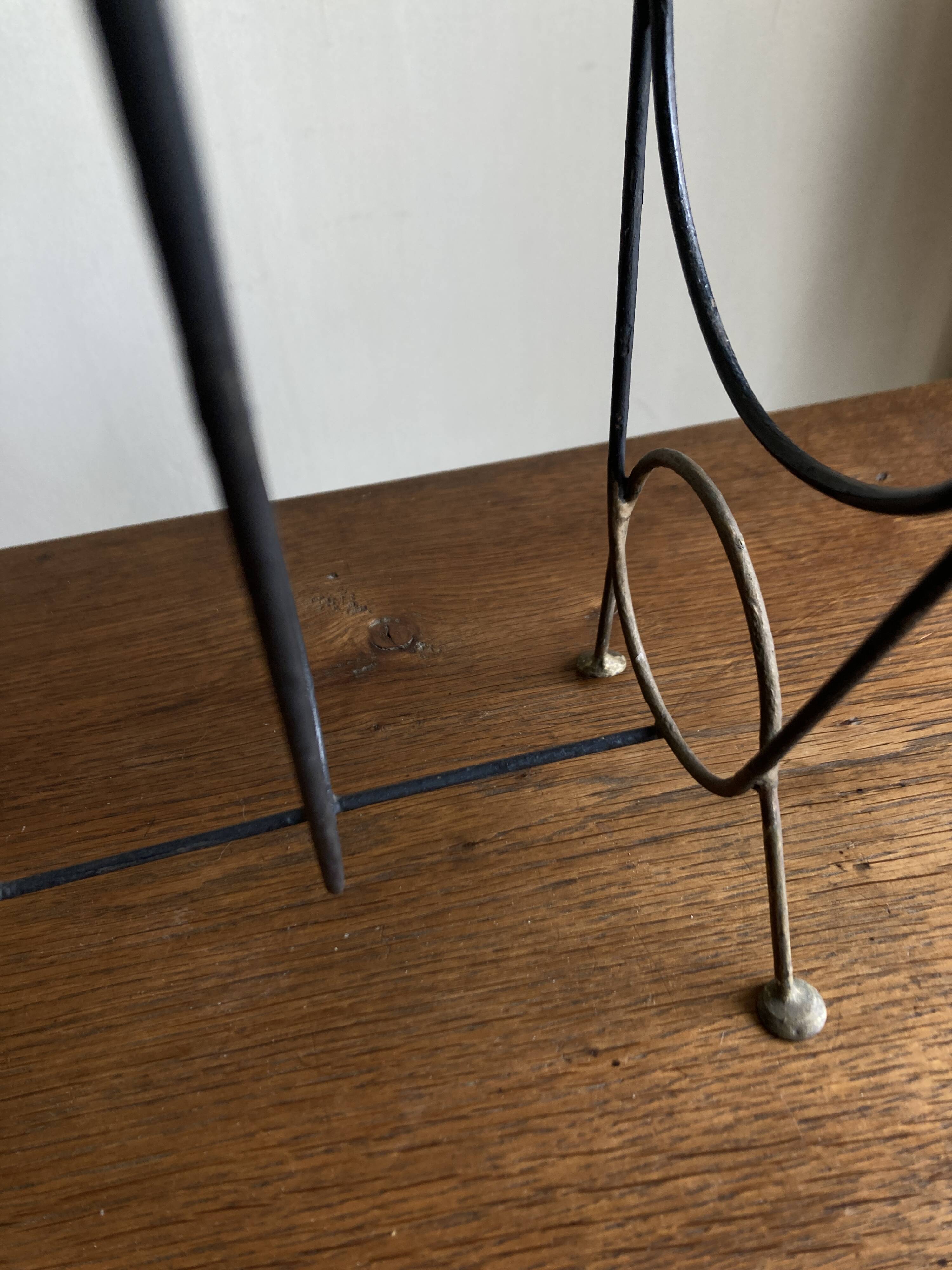 Mid-century poetic magazine rack in black metal