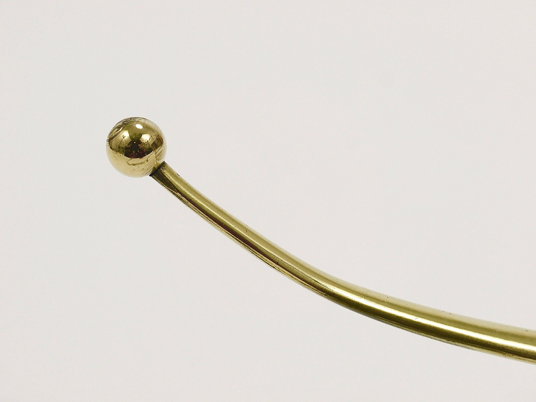 Two curved wall coat racks in brass by Franz Hagenauer, Vienna, mid-20th century, 1950s.