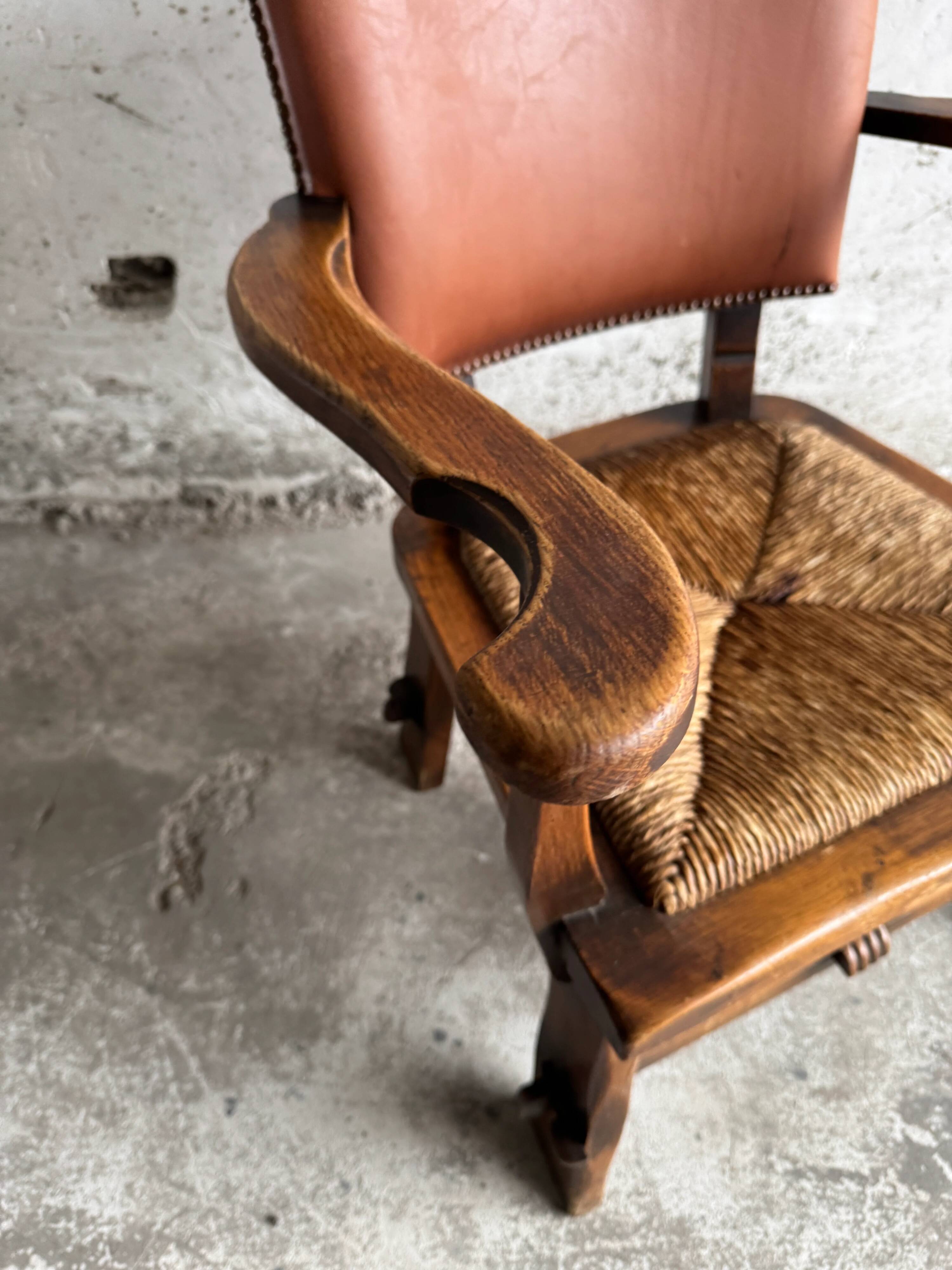 Brutalist dark brown solid wood armchair with natural rattan seat and cognac leather back