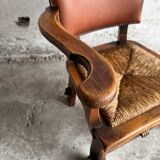 Brutalist dark brown solid wood armchair with natural rattan seat and cognac leather back