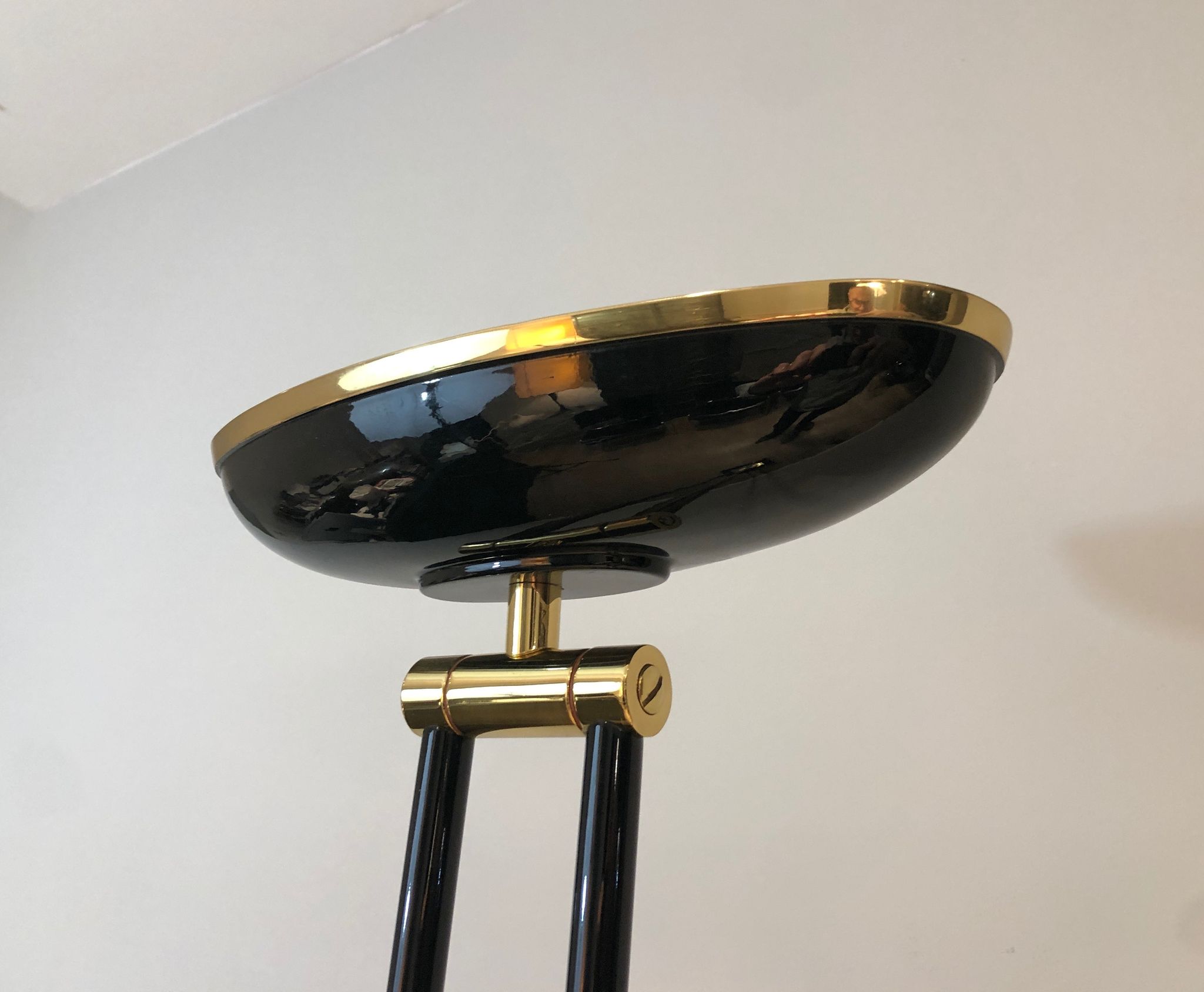 Black lacquered metal floor lamp with brass.