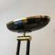 Black lacquered metal floor lamp with brass.