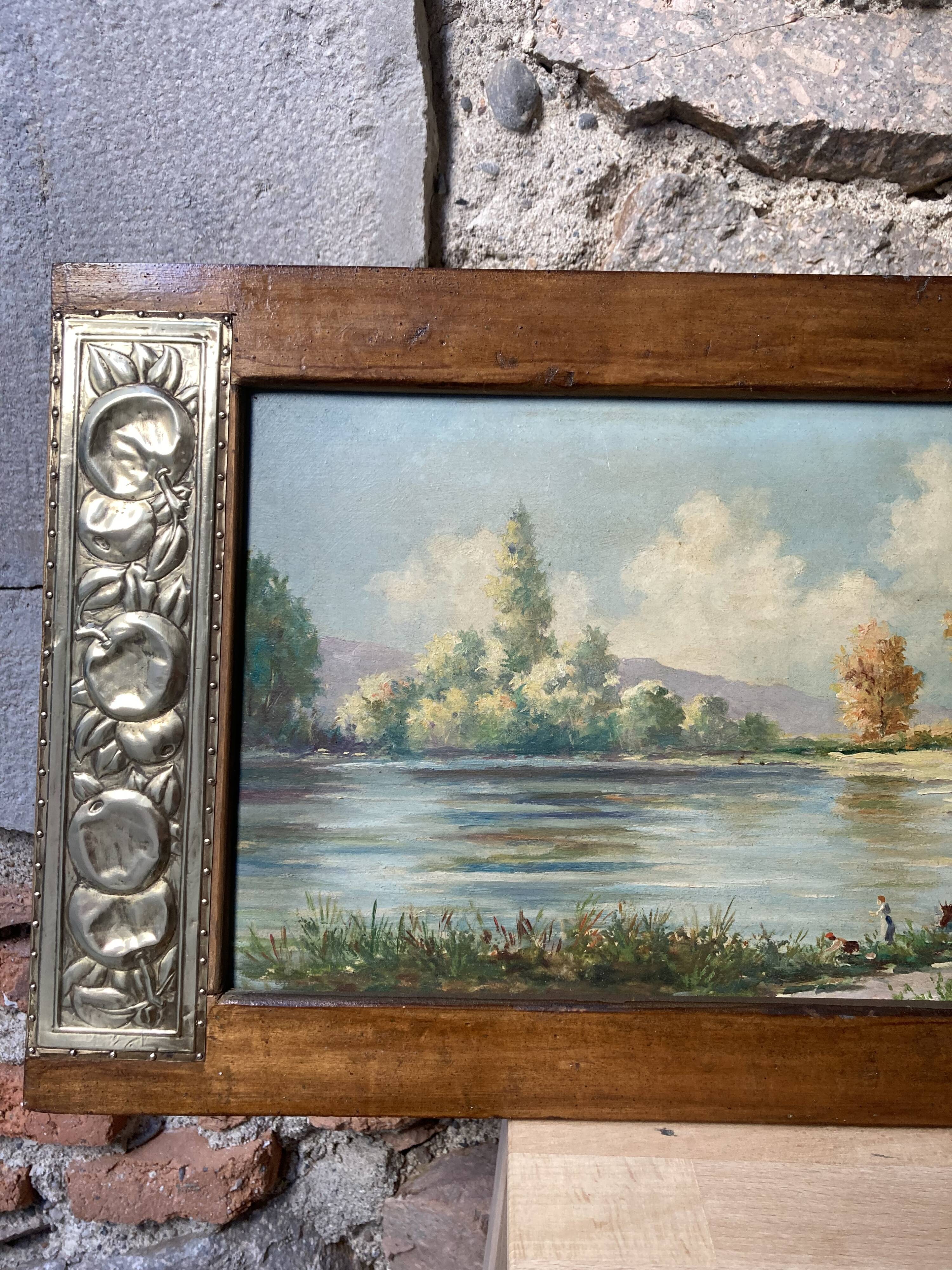 Pair of Art Deco wood and embossed metal landscape frames