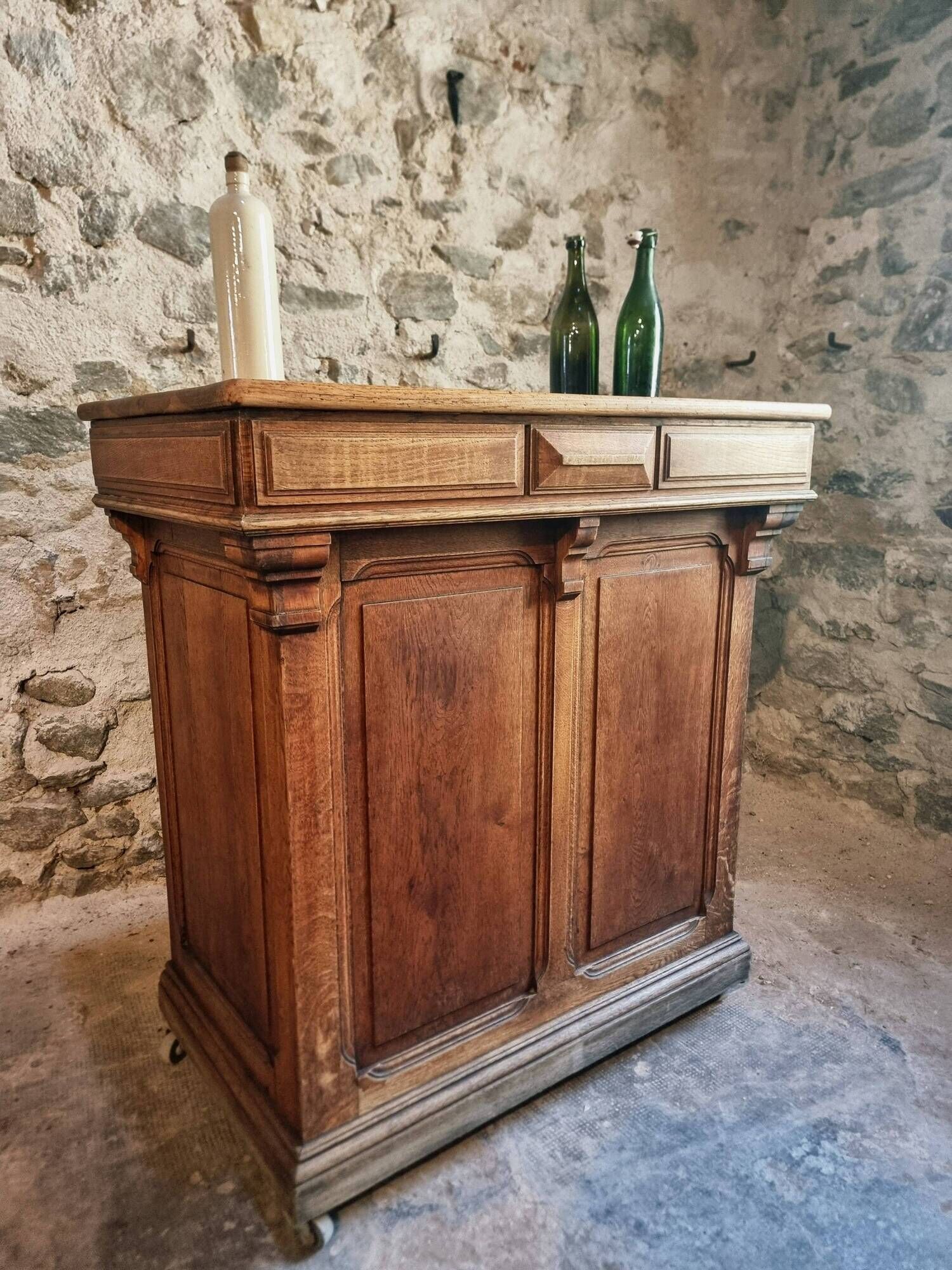 Antique French oak shop counter, kitchen island on wheels, circa 1880–1900.