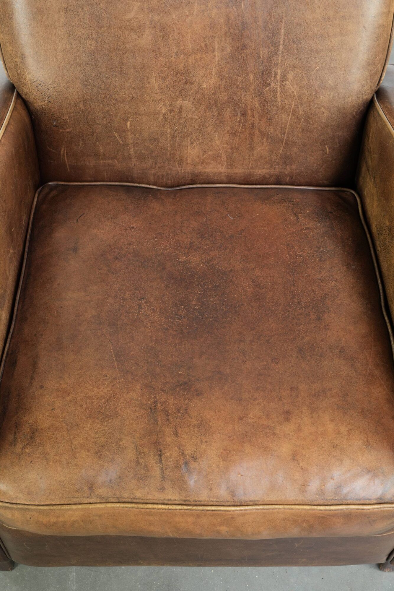 Sheepskin armchair in a light cognac colour with matching piping