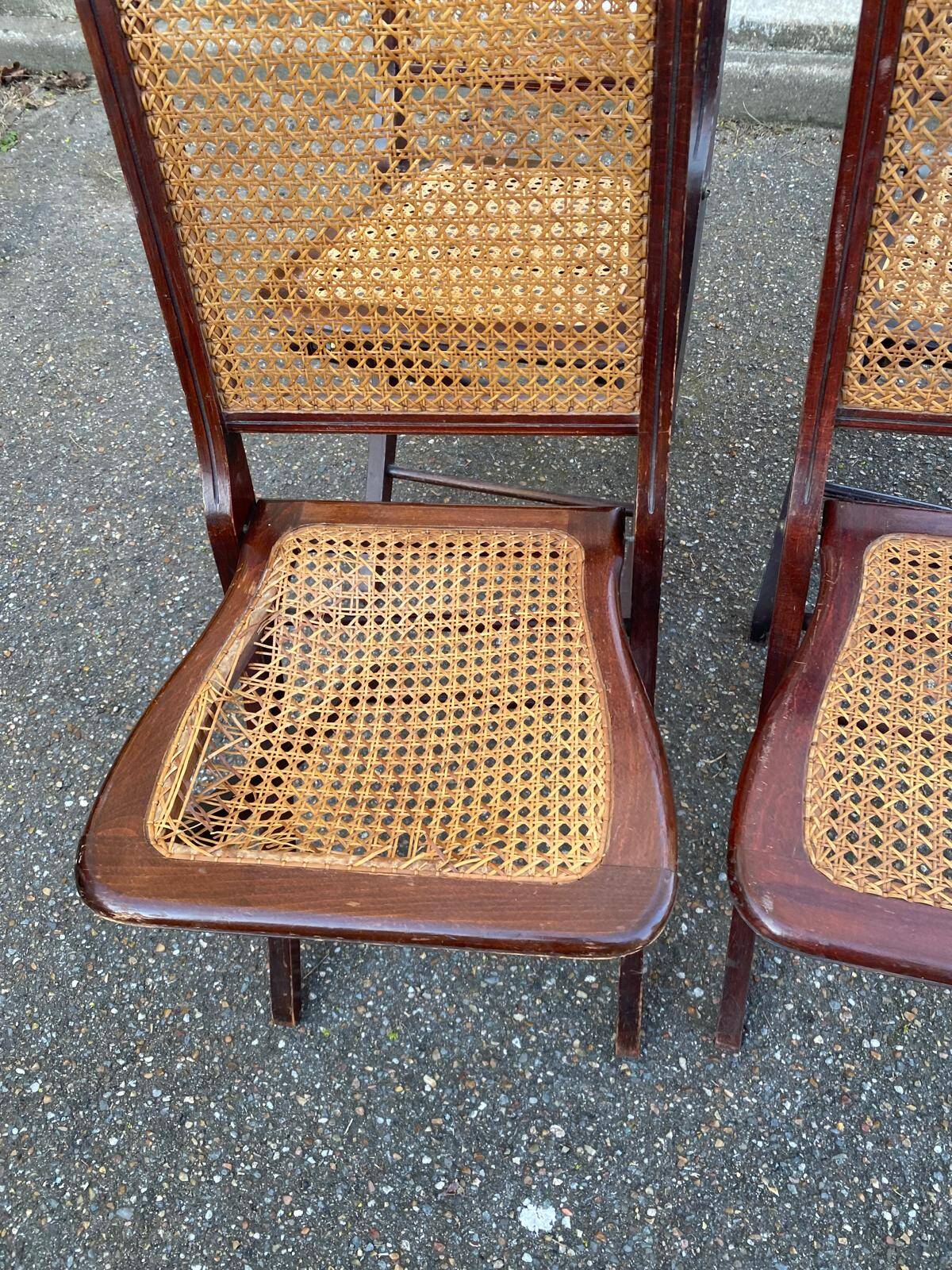 4 cane-seated solid wood folding chairs to be repaired.