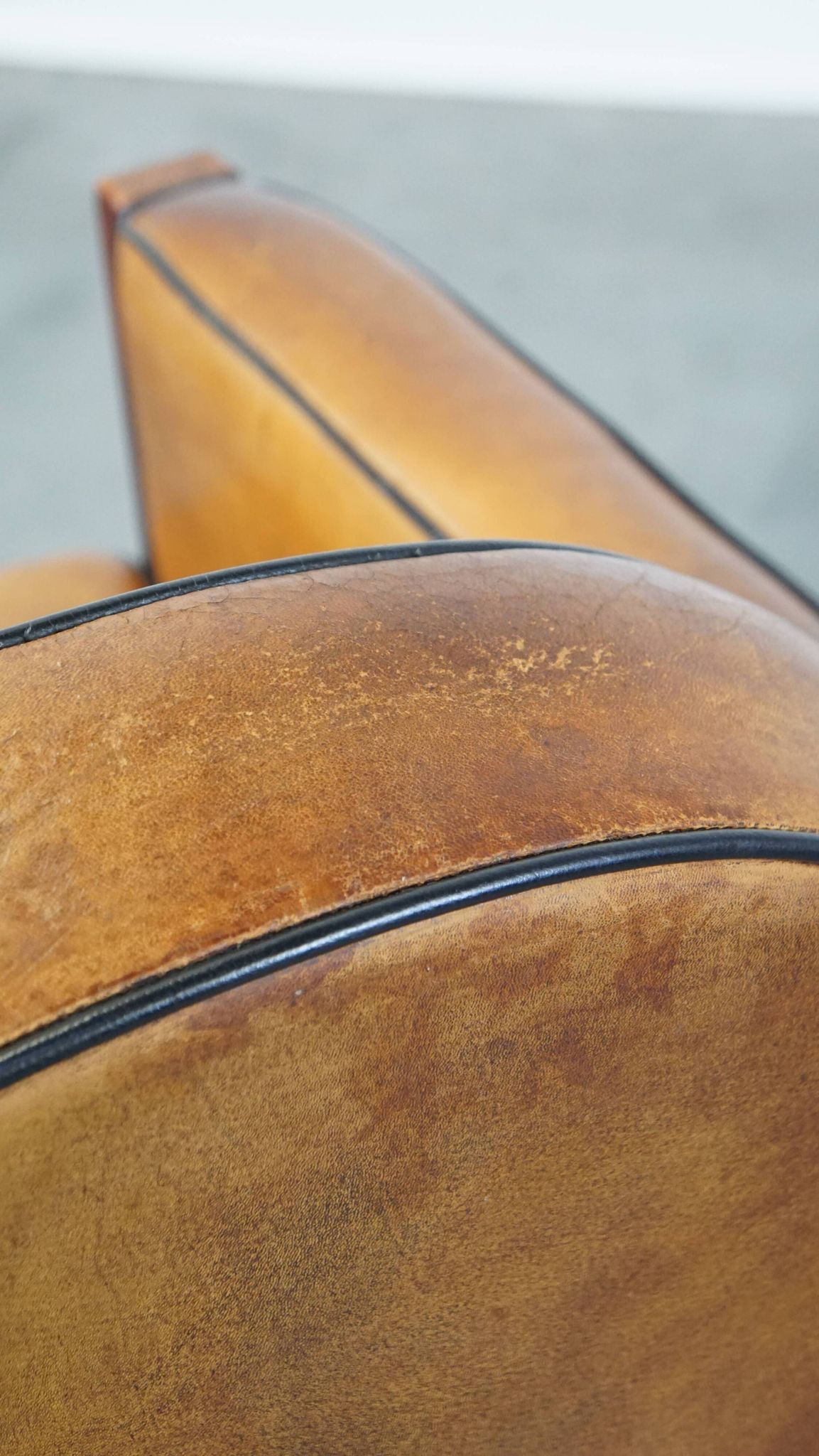 Sheep leather and wooden Art Deco design armchair with ball feet