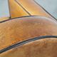 Sheep leather and wooden Art Deco design armchair with ball feet