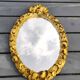 Hollywood Regency style oval Victorian mirror. In antique gold wood. 31 x 21cm